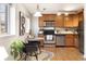 Eat-in kitchen with stainless steel appliances and wood cabinets at 1419 Detroit St # 25, Denver, CO 80206
