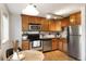 Updated kitchen with stainless steel appliances and wood cabinets at 1419 Detroit St # 25, Denver, CO 80206