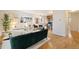 Open living room with hardwood floors and teal couch at 1419 Detroit St # 25, Denver, CO 80206