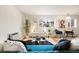 Bright living room with hardwood floors and teal couch at 1419 Detroit St # 25, Denver, CO 80206