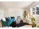 Well-lit living room boasts a comfortable blue sofa, modern decor, and hardwood floors at 1419 Detroit St # 25, Denver, CO 80206
