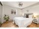 Serene main bedroom with a comfortable bed, ceiling fan, and ample natural light at 1419 Detroit St # 25, Denver, CO 80206