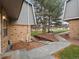 Exterior view of landscaped common area, bench and pathway between the townhomes at 1517 S Owens St # 9, Denver, CO 80232