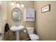 Bathroom featuring a pedestal sink, toilet and cabinet at 1517 S Owens St # 9, Denver, CO 80232