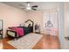 Comfortable bedroom with a ceiling fan, large window, and stylish decor at 1517 S Owens St # 9, Denver, CO 80232