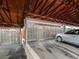 Carport with wooden frame roof and a silver sedan parked under the shelter at 1517 S Owens St # 9, Denver, CO 80232