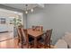 Dining area with hardwood floors, hanging pendant lights, and seating for four at 1517 S Owens St # 9, Denver, CO 80232