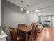 Well-lit dining room with hardwood floors and a wood dining set, adjacent to living area at 1517 S Owens St # 9, Denver, CO 80232