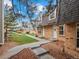 Exterior row of townhomes with brick facades, well maintained lawns and colorful mulch at 1517 S Owens St # 9, Denver, CO 80232