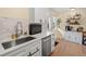 Modern kitchen with stainless steel appliances, white cabinets, and natural light at 1517 S Owens St # 9, Denver, CO 80232