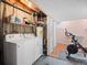 Cozy laundry area with washer, dryer, shelving, and exercise space for added convenience at 1517 S Owens St # 9, Denver, CO 80232