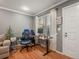 Inviting living room with hardwood floors, neutral paint, and a home office space at 1517 S Owens St # 9, Denver, CO 80232