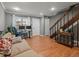 Inviting living room with hardwood floors, staircase, and natural light at 1517 S Owens St # 9, Denver, CO 80232