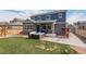 View of the backyard with a hot tub, patio, seating, and outdoor grilling area at 6889 E 119Th Ave, Thornton, CO 80233