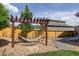 Cozy backyard featuring a hammock hung from a wooden pergola with a stone and woodchip path at 6889 E 119Th Ave, Thornton, CO 80233