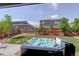 View of the backyard with a hot tub and well-maintained lawn and landscaping at 6889 E 119Th Ave, Thornton, CO 80233