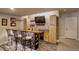 Finished basement bar area with custom countertop and brick accent wall at 6889 E 119Th Ave, Thornton, CO 80233