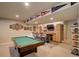 Finished basement featuring a pool table, bar with brick backsplash, and sports decor at 6889 E 119Th Ave, Thornton, CO 80233