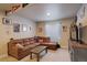 Finished basement featuring a comfortable couch, entertainment center, and cozy lighting at 6889 E 119Th Ave, Thornton, CO 80233