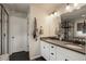 This bathroom features a double vanity, modern fixtures, and a tiled walk-in shower at 6889 E 119Th Ave, Thornton, CO 80233