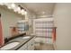 Bright bathroom showcasing a shower with a striped curtain, and double sinks at 6889 E 119Th Ave, Thornton, CO 80233