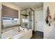 The bathroom includes a tiled walk-in shower, soaking tub, and modern finishes at 6889 E 119Th Ave, Thornton, CO 80233
