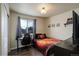 Comfortable bedroom with wood-look floors, natural light, a closet, and a TV at 6889 E 119Th Ave, Thornton, CO 80233