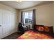 Teen bedroom with wood-look floors, closet and an exterior view through the window at 6889 E 119Th Ave, Thornton, CO 80233