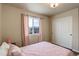 Cozy bedroom featuring wood-look floors, a light fixture, and a sliding-door closet at 6889 E 119Th Ave, Thornton, CO 80233
