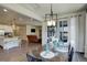 Open-concept view of the dining area into the kitchen and living room at 6889 E 119Th Ave, Thornton, CO 80233
