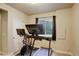 Home gym space with carpet flooring, white walls and a stationary bike and treadmill at 6889 E 119Th Ave, Thornton, CO 80233