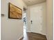 Entryway with hardwood floors and a view into the adjacent living space at 6889 E 119Th Ave, Thornton, CO 80233