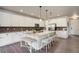 Bright kitchen features an island with bar seating, granite countertops, and stylish backsplash at 6889 E 119Th Ave, Thornton, CO 80233