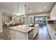 Open concept kitchen with island is open to the dining and living areas at 6889 E 119Th Ave, Thornton, CO 80233