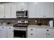 The modern kitchen features stainless steel appliances, granite countertops, and ample cabinet space at 6889 E 119Th Ave, Thornton, CO 80233
