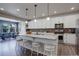 Kitchen features a central island with counter seating and pendant lighting. Dining area visible in background at 6889 E 119Th Ave, Thornton, CO 80233