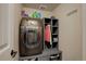 Laundry room featuring a gray washer and dryer set with shelving and gray cabinets at 6889 E 119Th Ave, Thornton, CO 80233