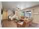 Spacious living room with hardwood floors, large windows, and comfortable leather furniture at 6889 E 119Th Ave, Thornton, CO 80233