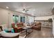 Bright living room with open concept design and hardwood floors connecting to kitchen at 6889 E 119Th Ave, Thornton, CO 80233