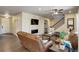 Open living room with modern fireplace and seamless flow to the kitchen at 6889 E 119Th Ave, Thornton, CO 80233
