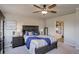 Relaxing main bedroom with ceiling fan, ensuite bathroom, and carpeted floors at 6889 E 119Th Ave, Thornton, CO 80233