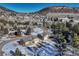 An aerial view of two homes in a quaint neighborhood with mountain scenery at 93 Greeley Blvd, Palmer Lake, CO 80133