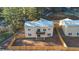 Aerial view of a private backyard featuring a wooden fence, a small balcony, and a patio area perfect for outdoor living at 93 Greeley Blvd, Palmer Lake, CO 80133