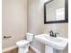 Clean half-bathroom featuring a pedestal sink and modern fixtures at 93 Greeley Blvd, Palmer Lake, CO 80133
