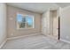 Well-lit bedroom with a large window, neutral color palette, and comfortable carpeting at 93 Greeley Blvd, Palmer Lake, CO 80133