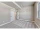 Bedroom features neutral walls, gray carpet flooring, and entryways to other rooms and closet at 93 Greeley Blvd, Palmer Lake, CO 80133