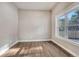 Well-lit room with wood floors, a large window, and neutral paint at 93 Greeley Blvd, Palmer Lake, CO 80133
