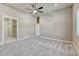 Spacious bedroom features neutral walls, carpeted flooring, and entryways to other rooms at 93 Greeley Blvd, Palmer Lake, CO 80133