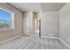 Bright bedroom features a large window, neutral color palette, plush carpet, and ensuite access at 93 Greeley Blvd, Palmer Lake, CO 80133
