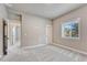 A spacious bedroom with neutral tones, plush carpeting, and natural light from a window at 93 Greeley Blvd, Palmer Lake, CO 80133
